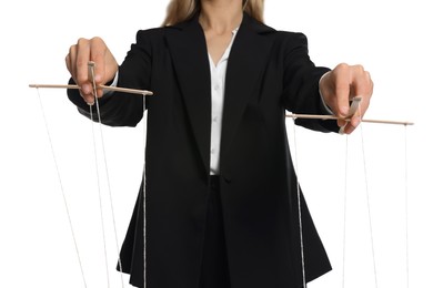 Woman in suit pulling strings of puppet on white background, closeup