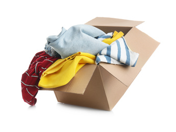 Photo of Cardboard box with clothes isolated on white