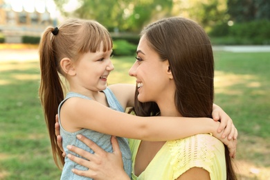 Mother with her cute child in green park on sunny day. Happy family