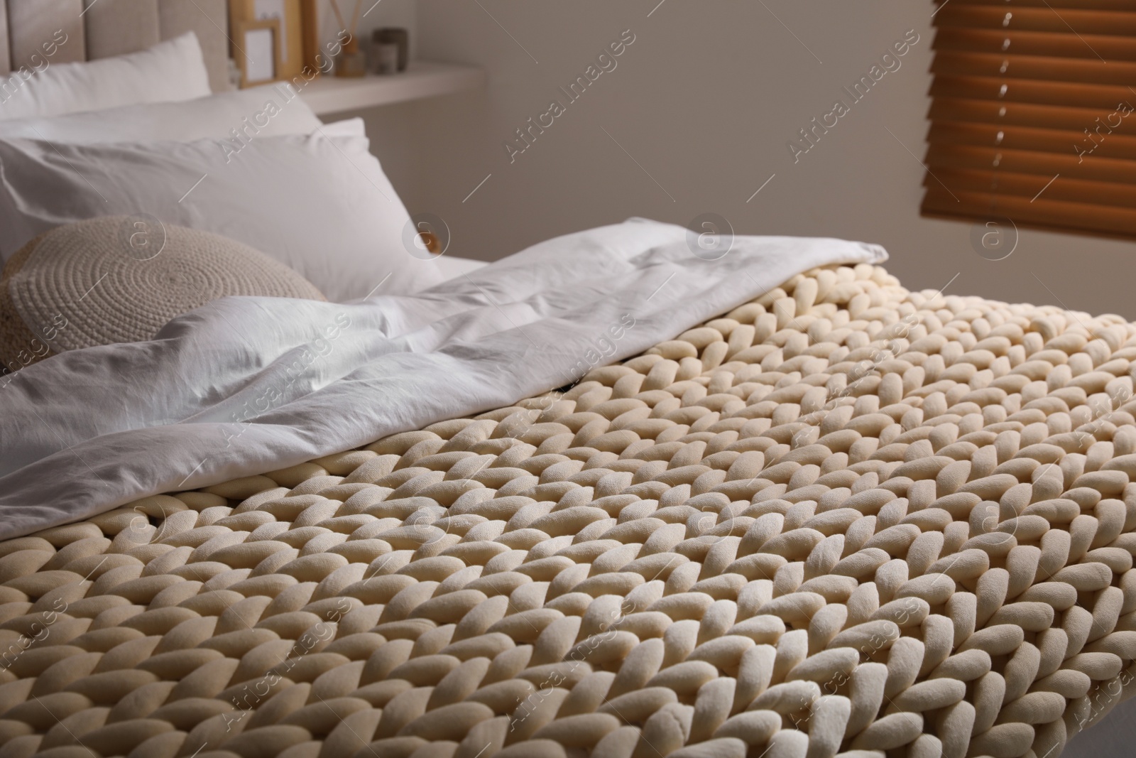 Photo of Soft chunky knit blanket on bed indoors