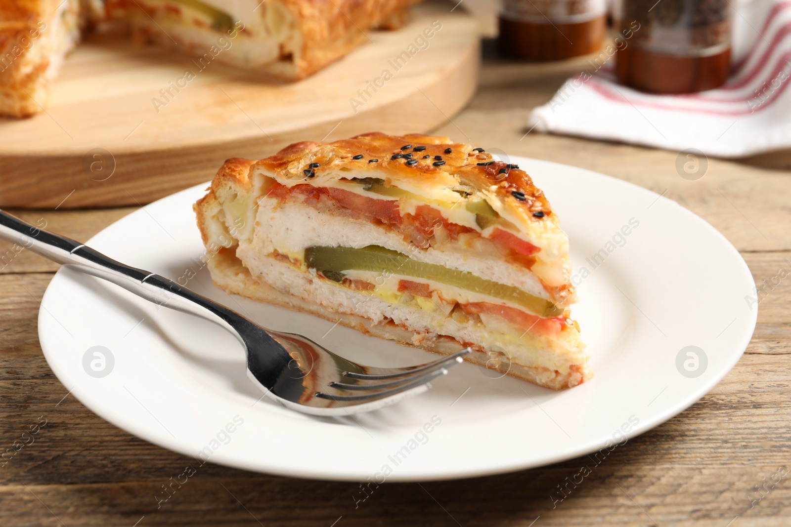 Photo of Piece of tasty homemade pie with filling served on wooden table