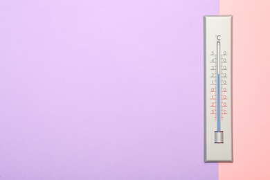 Photo of Weather thermometer on color background, top view. Space for text