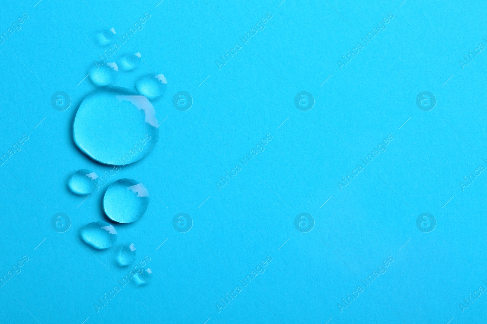 Photo of Water drops on color background, top view. Space for text