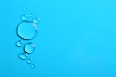 Water drops on color background, top view. Space for text