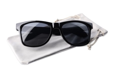 Photo of Stylish sunglasses with grey cloth bag on white background
