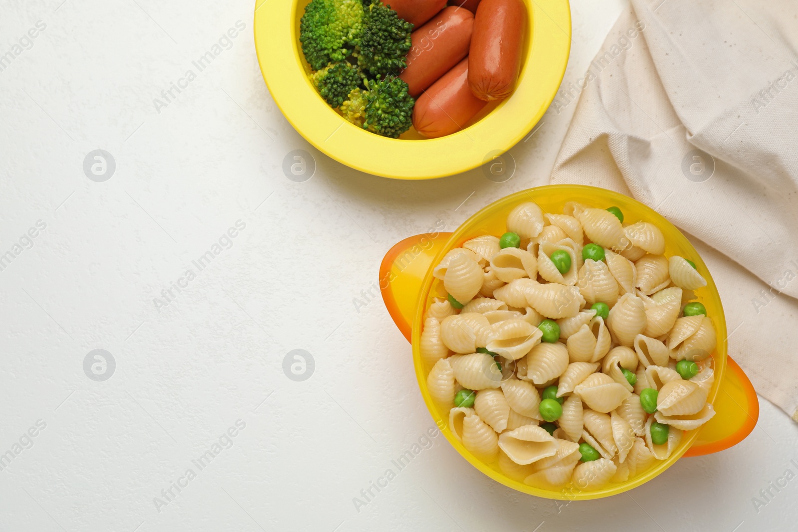 Photo of Bowl with tasty pasta on white table, flat lay. Space for text