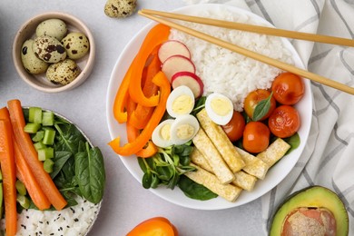 Delicious poke bowl and ingredients on light grey background, flat lay