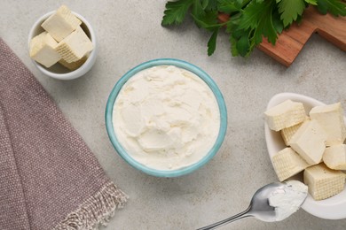 Photo of Delicious tofu cheese and spoon on light table, flat lay