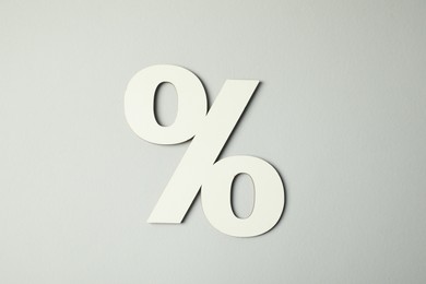 Photo of White percent sign on light grey background, top view