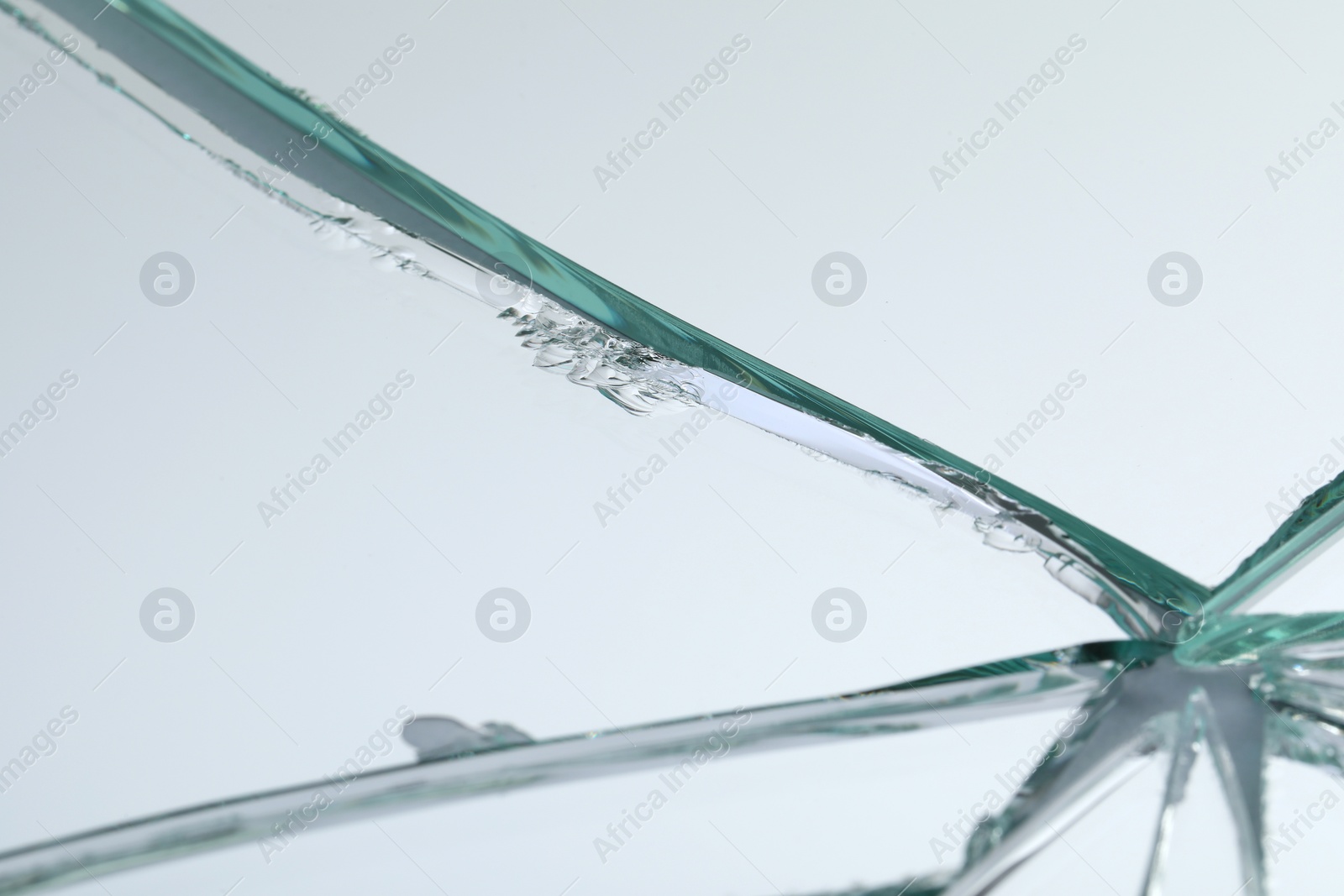 Photo of Broken mirror with many cracks as background, closeup view