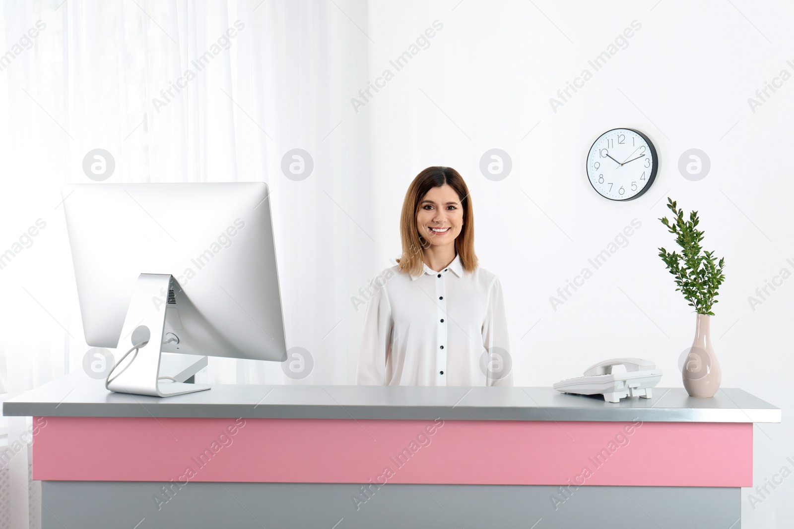 Photo of Portrait of beautiful woman at reception desk in beauty salon