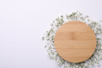 Blank wooden board with beautiful gypsophila flowers on white background, top view. Space for text