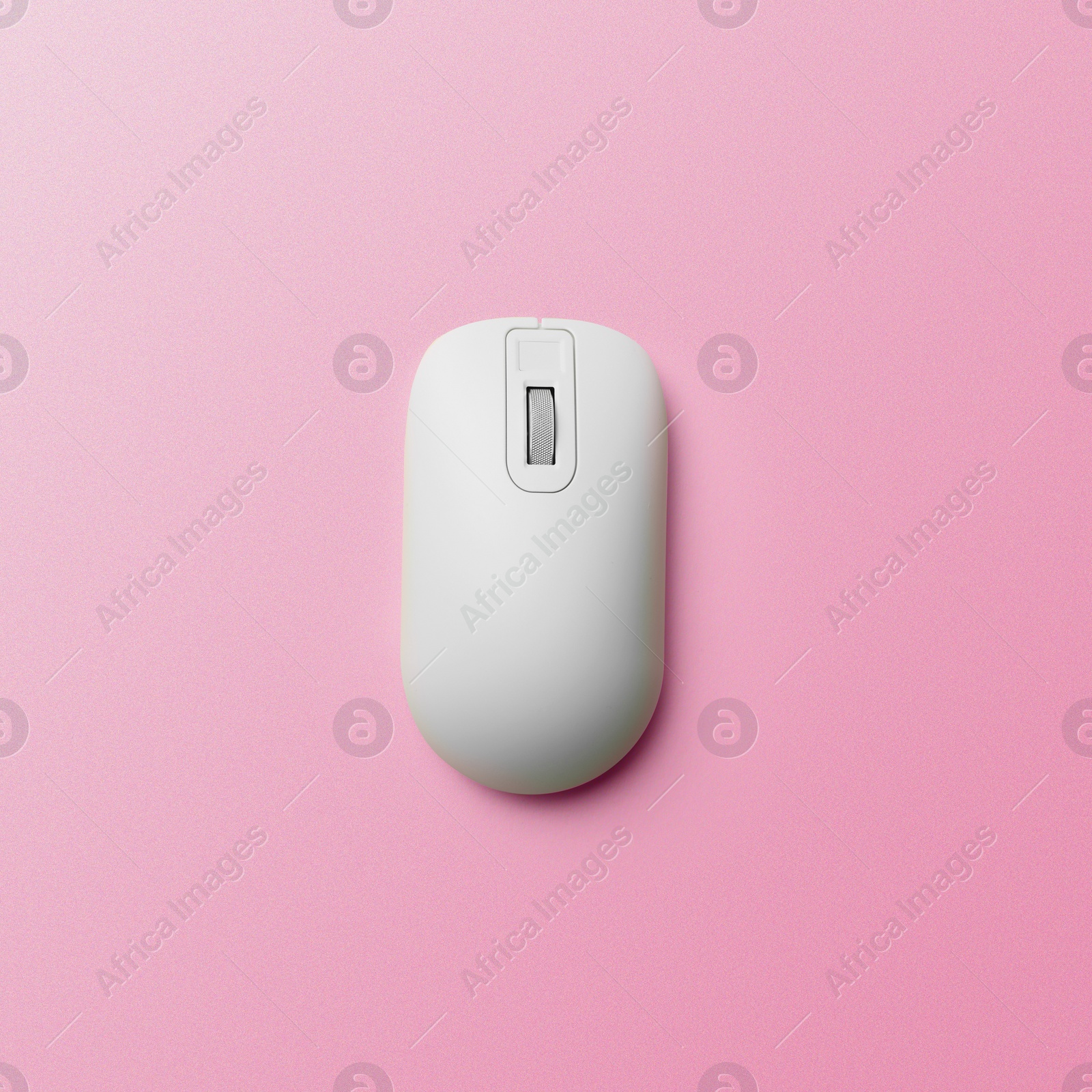 Image of Modern wireless computer mouse on pink background, top view