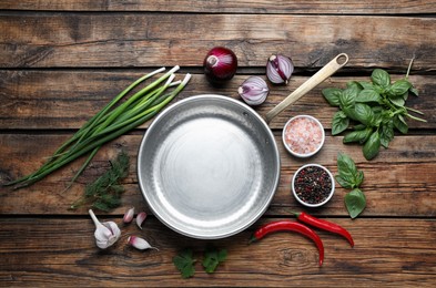 Photo of Flat lay composition with frying pan and fresh products on wooden table