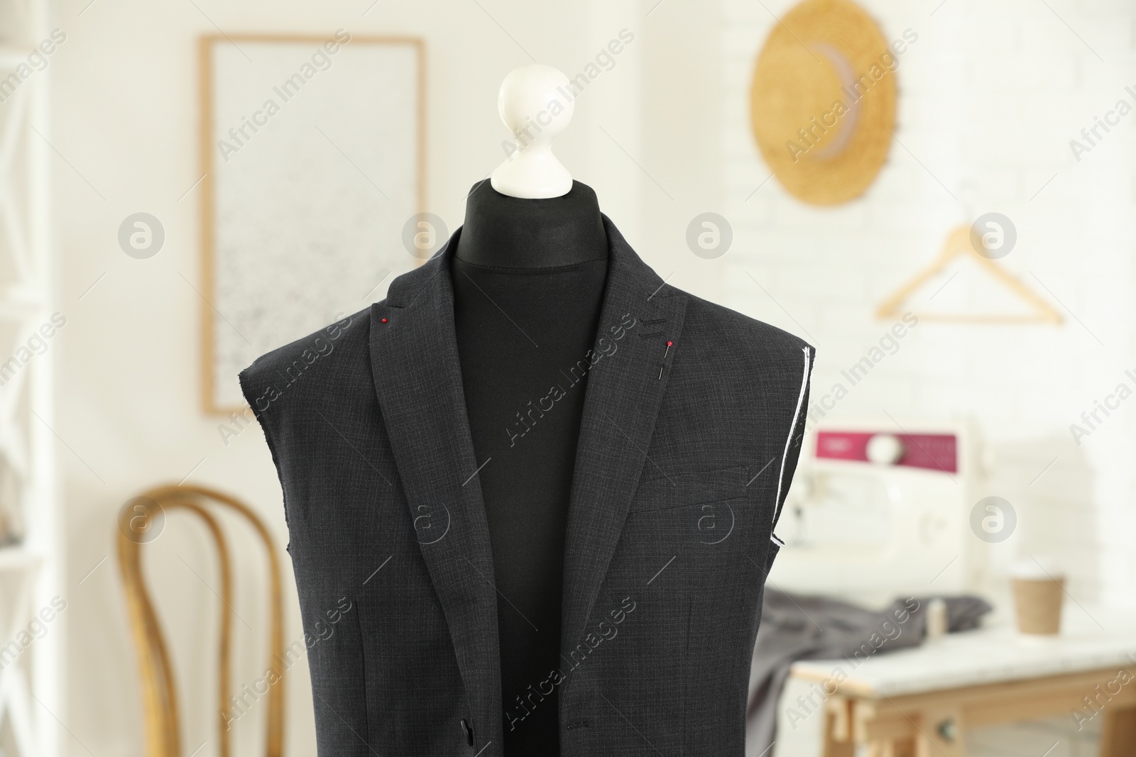 Photo of Mannequin with unfinished jacket in tailor shop