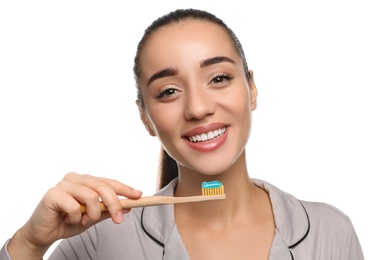 Photo of Woman holding toothbrush with paste on white background