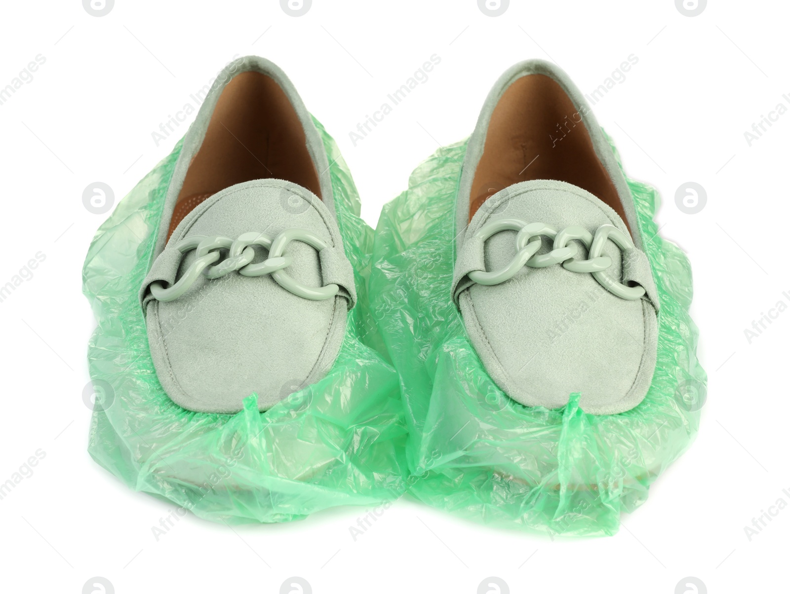 Photo of Women's mules in green shoe covers isolated on white