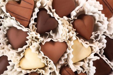 Delicious heart shaped chocolate candies as background, closeup