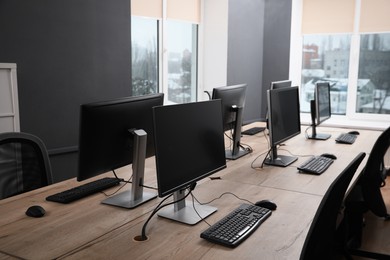 Photo of Many modern computers in open space office