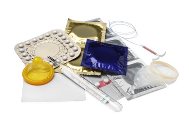 Photo of Contraceptive pills, condoms, intrauterine device and thermometer isolated on white. Different birth control methods