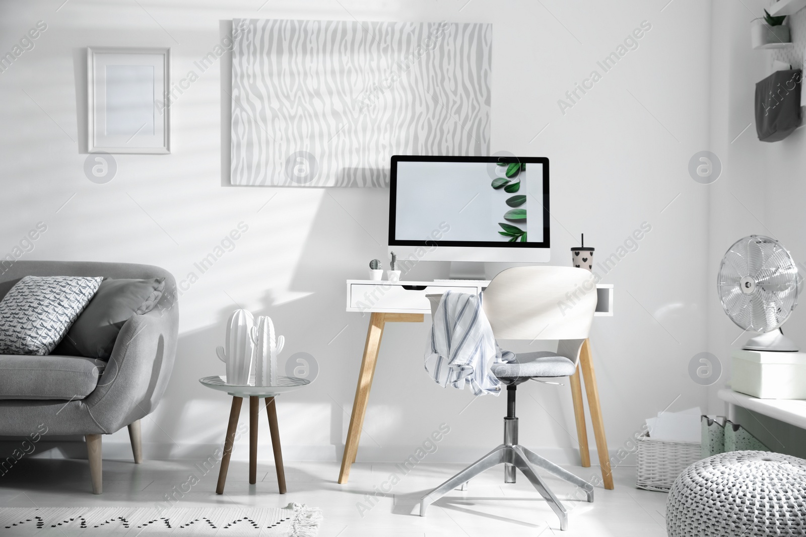 Photo of Comfortable office chair near desk with modern computer indoors