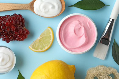 Flat lay composition with natural homemade mask, pomegranate and ingredients on blue background