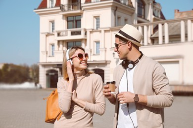 Couple of tourists walking on city street