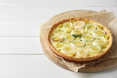 Photo of Tasty leek pie with thyme on white wooden table. Space for text