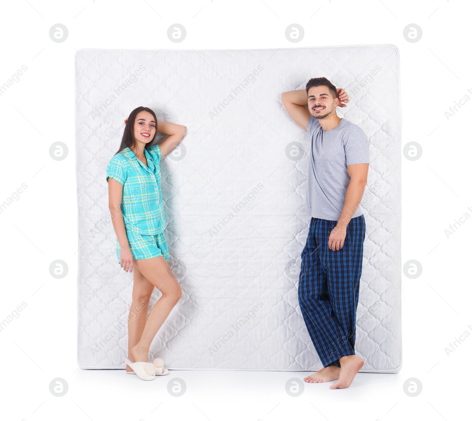 Photo of Young couple with comfortable mattress isolated on white