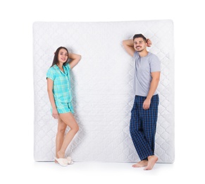 Photo of Young couple with comfortable mattress isolated on white