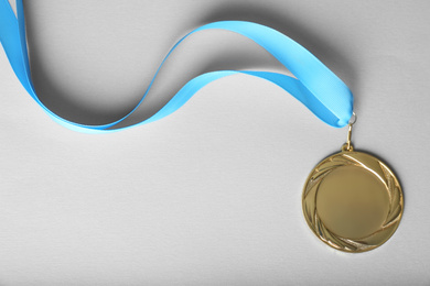 Gold medal on white background, top view. Space for design
