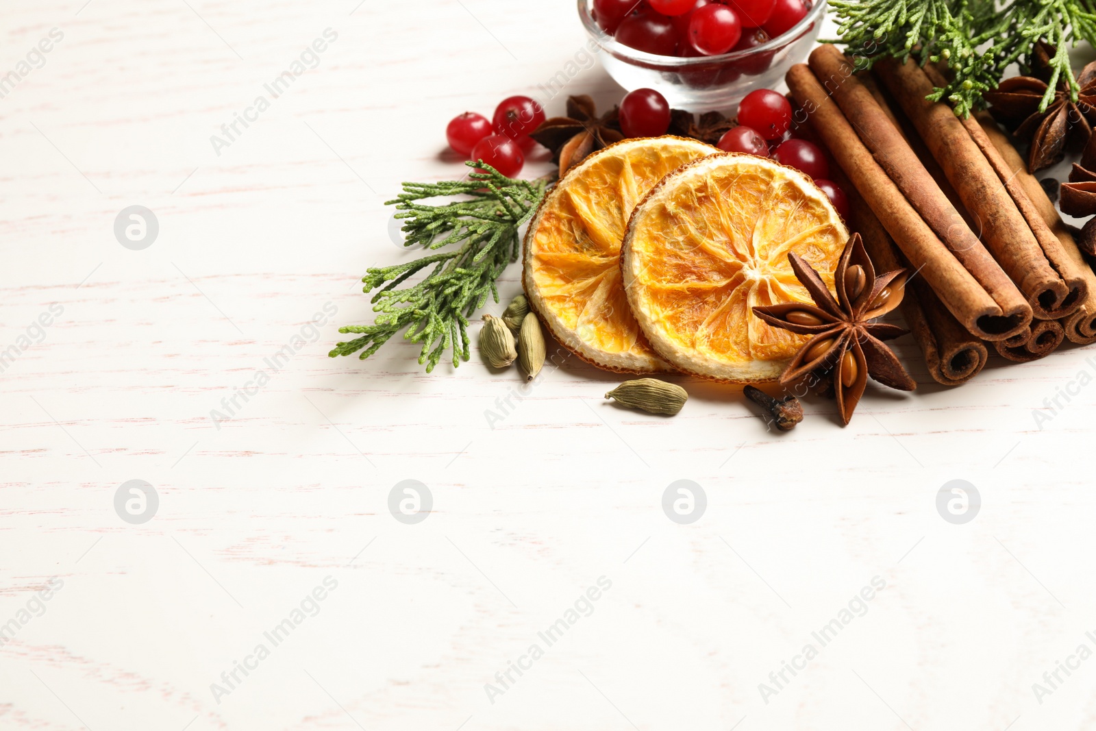 Photo of Composition with mulled wine ingredients on white table. Space for text