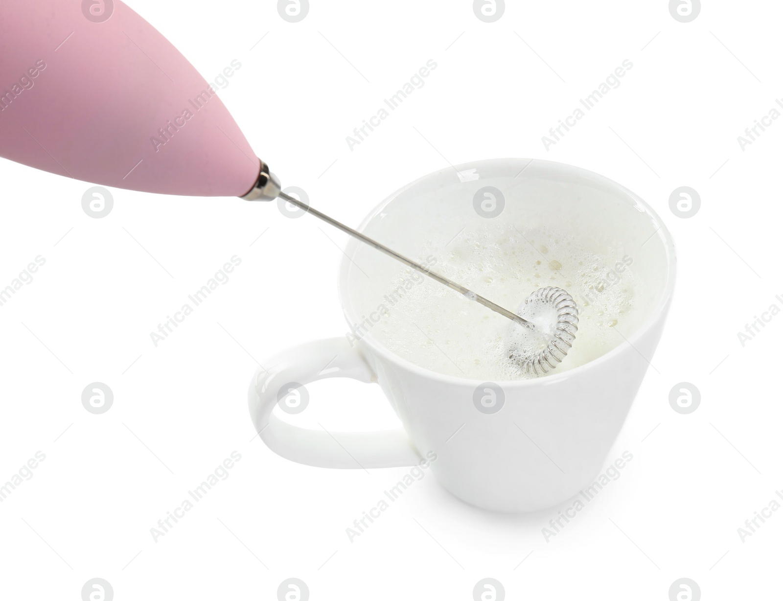 Photo of Whisking milk in cup with mini mixer (frother wand) isolated on white