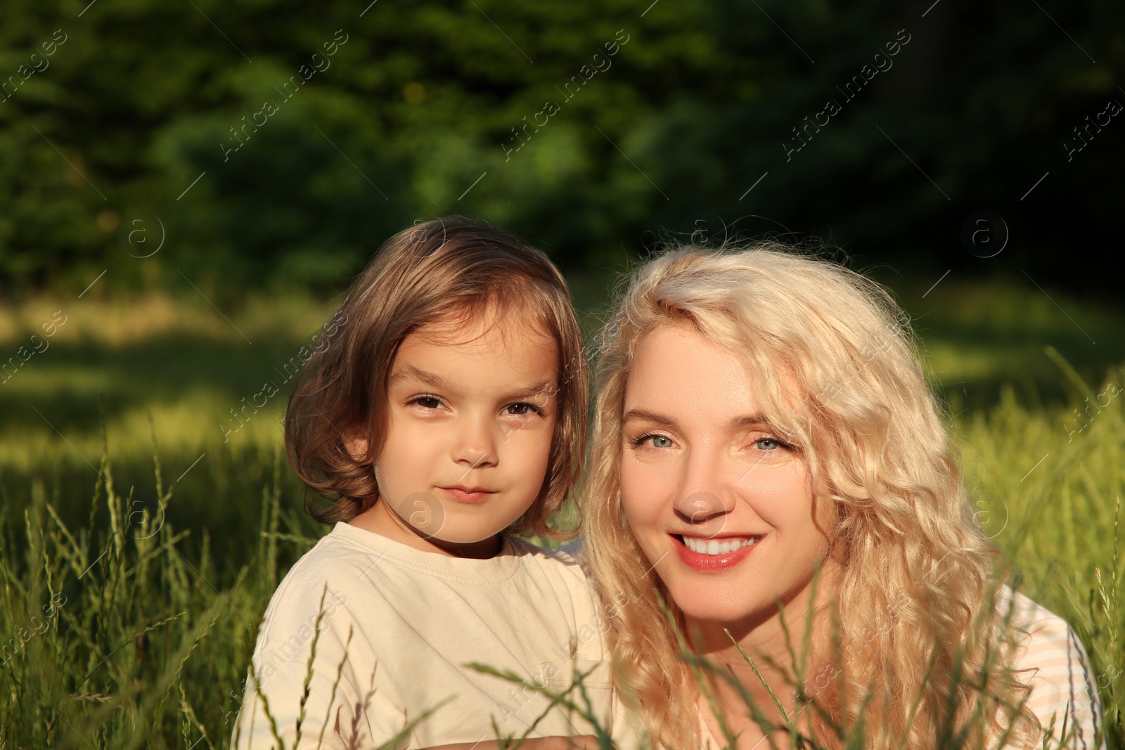 Photo of Happy mother with her cute daughter spending time together outdoors