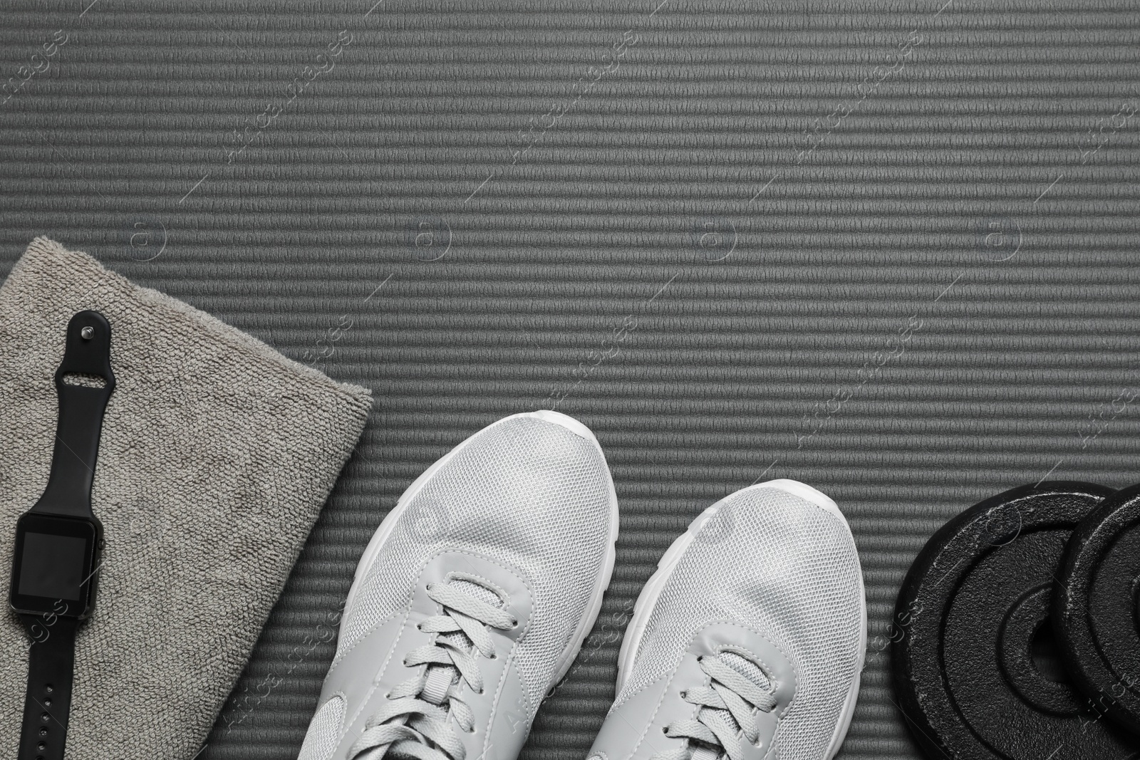 Photo of Flat lay composition with sports equipment on grey mat, space for text