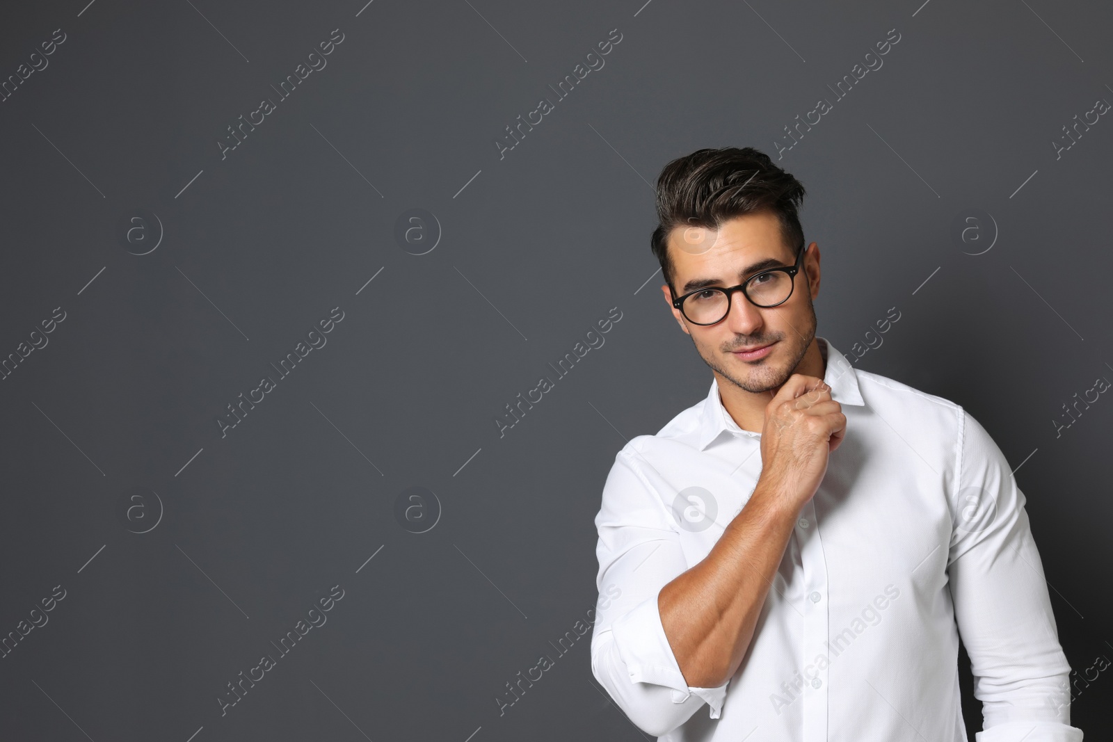 Photo of Portrait of handsome young man and space for text on black background