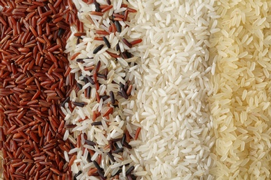 Brown and other types of rice as background, closeup