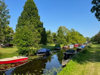 Photo of Canal with moored boats outdoors on sunny day