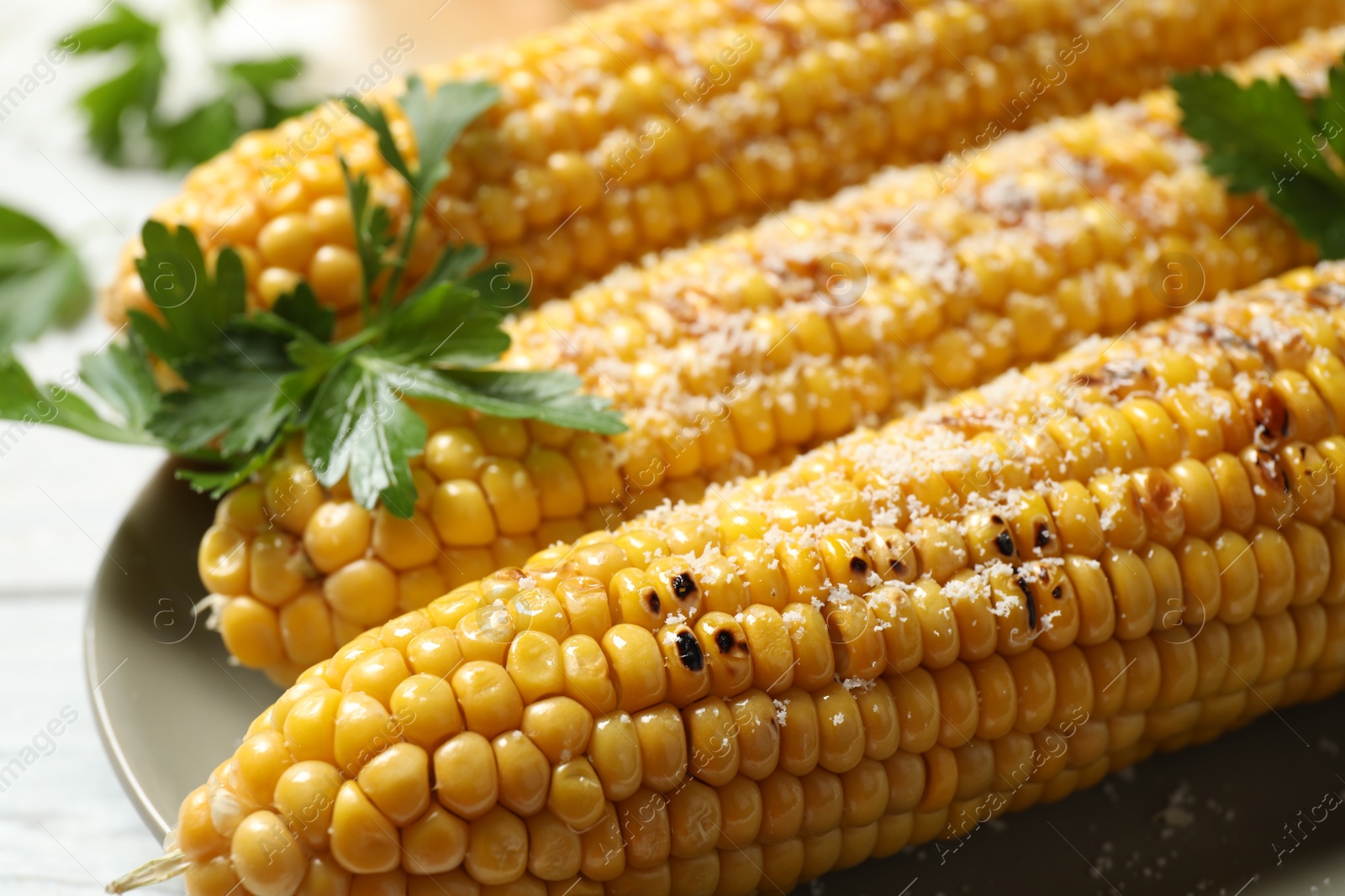 Photo of Tasty grilled corn with parmesan, closeup view