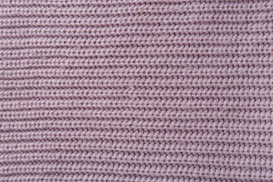 Photo of Beautiful violet knitted fabric as background, top view