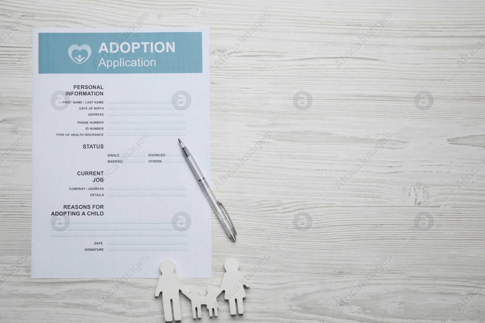 Photo of Adoption application, family figure and pen on white wooden table, flat lay. Space for text