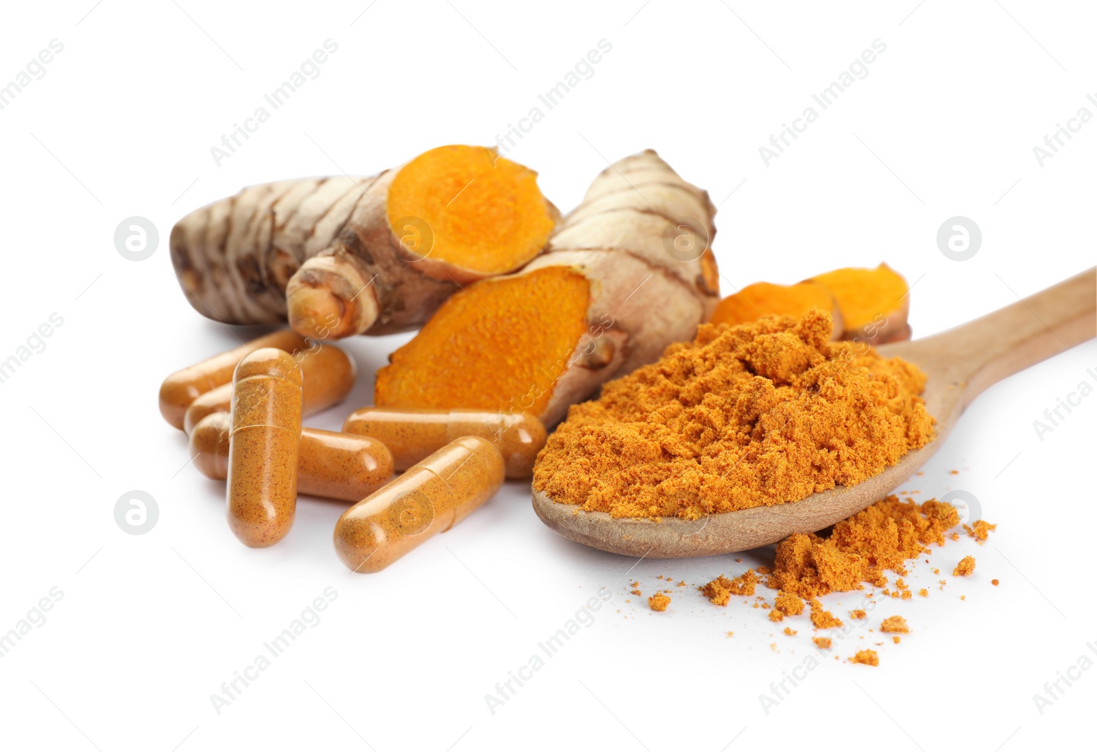 Photo of Spoon with aromatic turmeric powder, pills and raw roots isolated on white