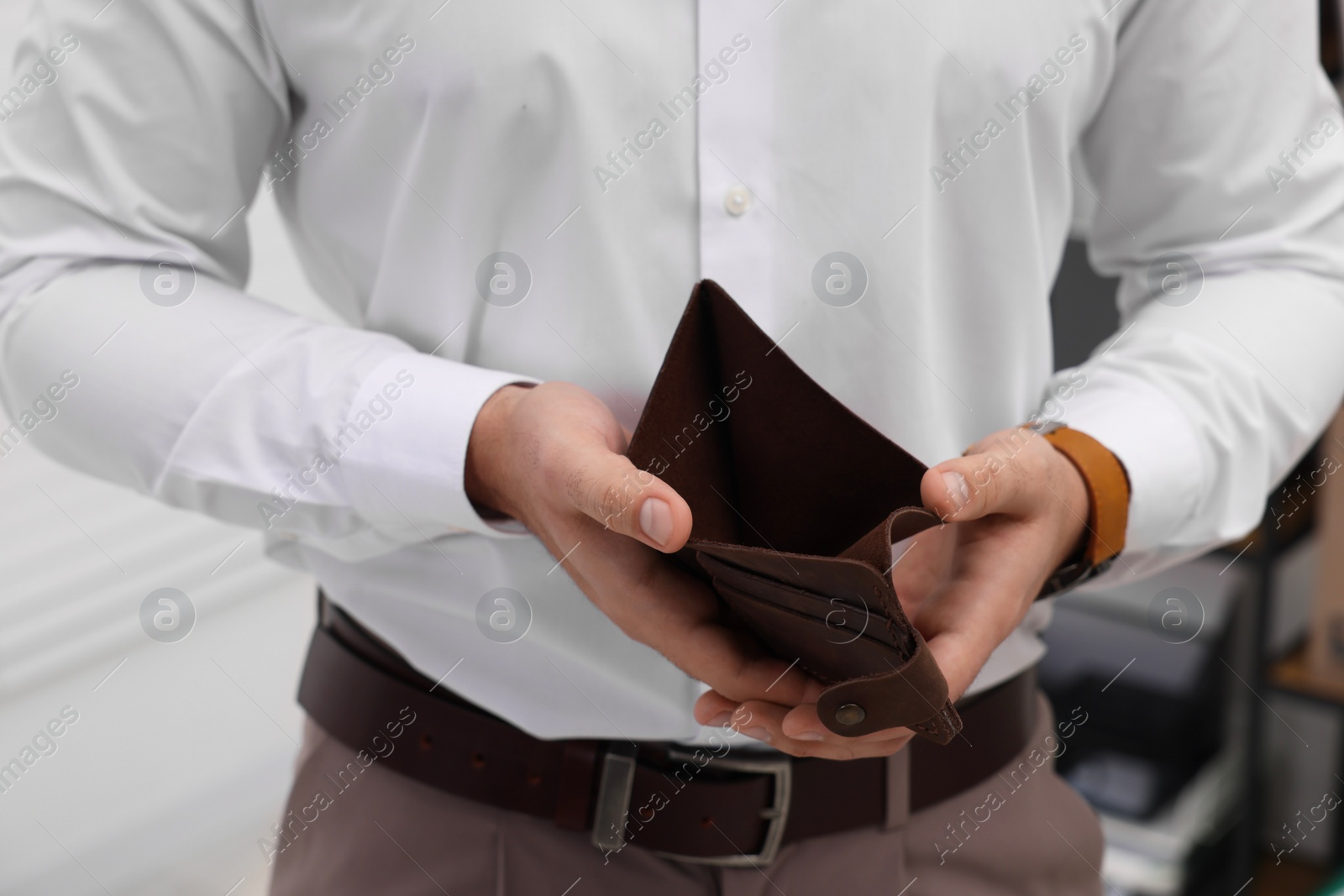 Photo of Man with empty wallet in office, closeup