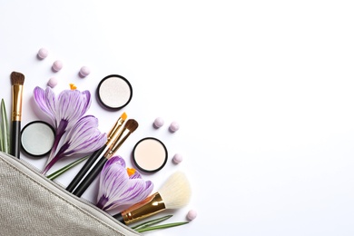 Photo of Makeup products, flowers and cosmetic bag on white background, top view