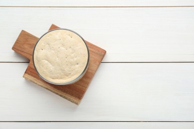Photo of Leaven on white wooden table, top view. Space for text
