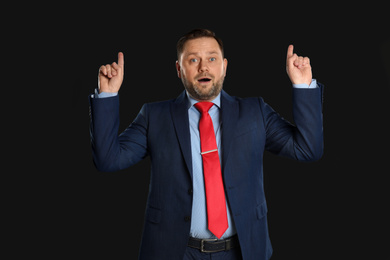 Photo of Portrait of emotional mature man on black background