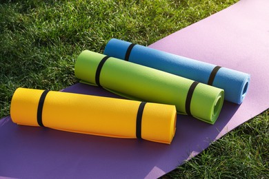 Bright exercise mats on fresh green grass outdoors