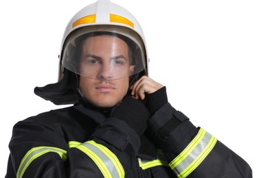 Photo of Portrait of firefighter in uniform wearing helmet on white background
