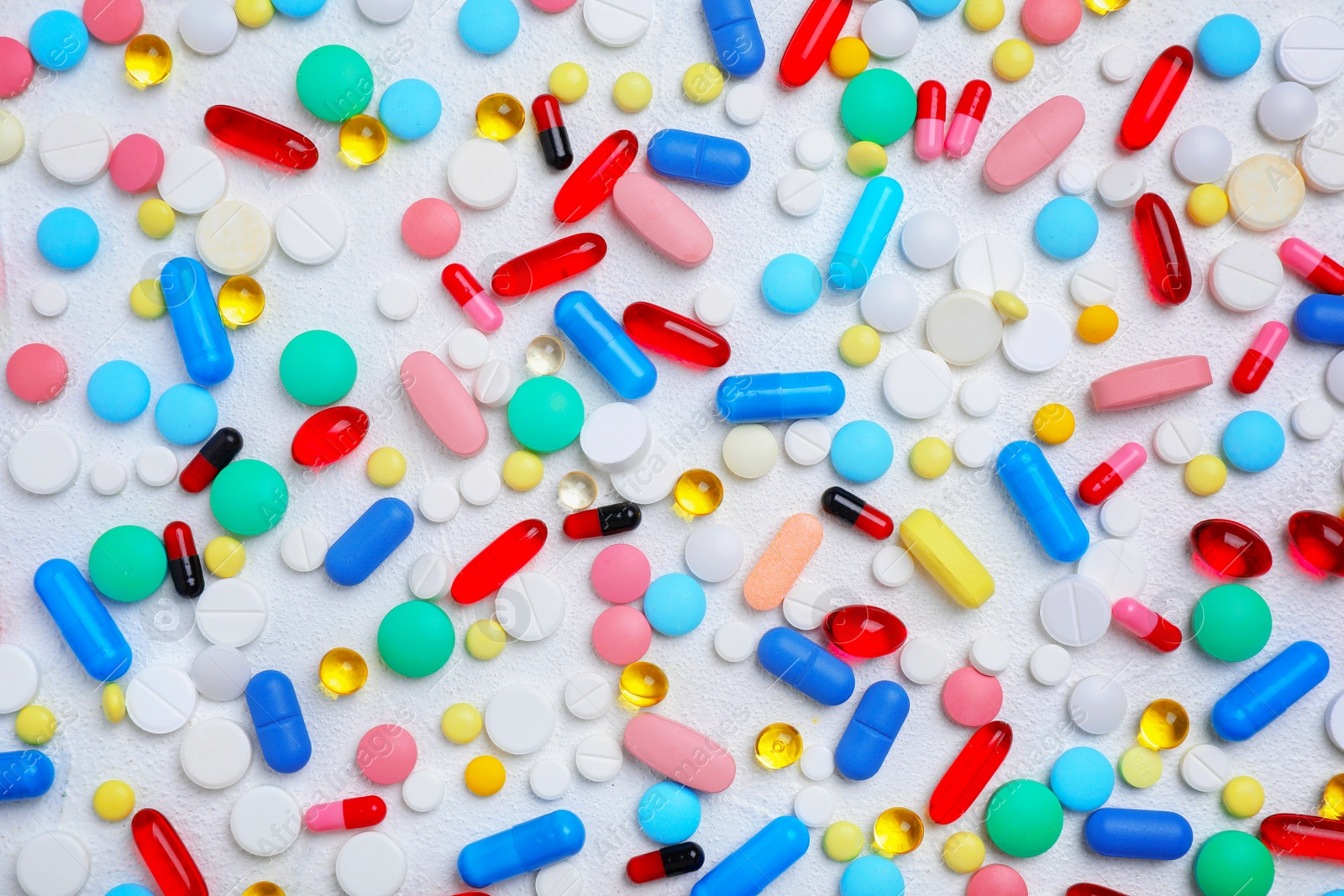 Photo of Different pills and capsules on white background, flat lay