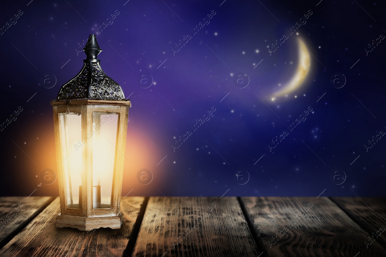 Image of Beautiful decorative Arabic lantern on wooden table at night, space for text. Fanous as Ramadan symbol